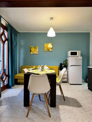 a kitchen with a table and chairs and a couch at Villa Nikoleta in Sveti Vlas