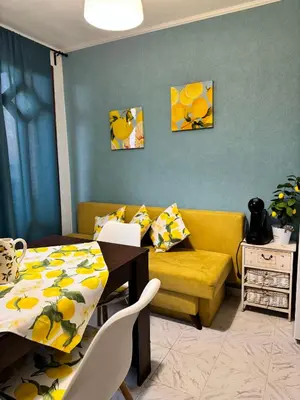 a living room with a table and a yellow couch at Vila Nikoleta in Sveti Vlas