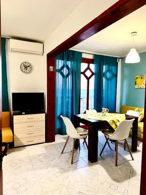 a living room with a dining room table and chairs at Vila Nikoleta in Sveti Vlas