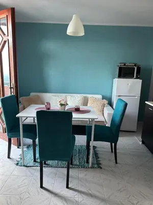a living room with a table and chairs and a couch at Vila Nikoleta in Sveti Vlas