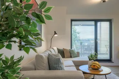 a living room with a couch and a table at INCANTO Residence in Varna City