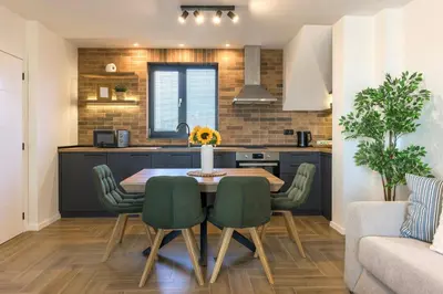 a kitchen and dining room with a table and chairs at INCANTO Residence in Varna City