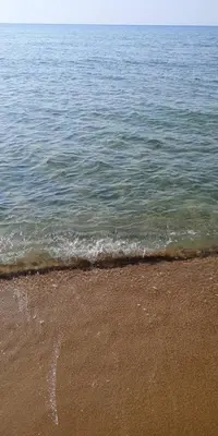 a sandy beach with the ocean and the water at Apartment 300m from private beach VILA ROMANA Royal Castle in Sveti Vlas