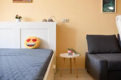 a bedroom with a bed and a chair at Sandy Dreams Cozy Studio in Pomorie