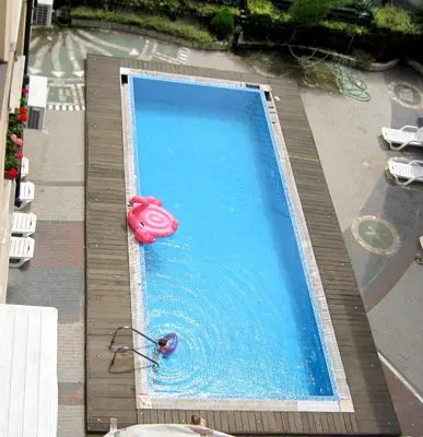 a swimming pool with a pink animal toy in it at Gnezdo Apartment Sarafovo in Burgas City