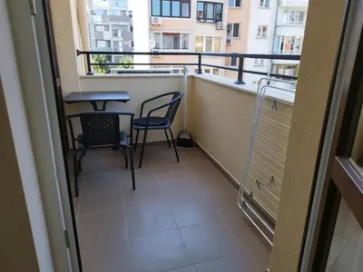 a balcony with two chairs and a table on it at RadiSun with Free Parking space in Burgas City