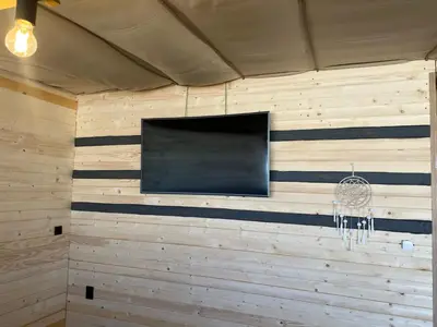 a wall with a flat screen tv in a room at Бунгало woodwave in Chernomorets