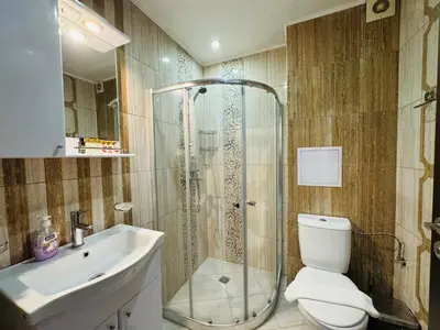 a bathroom with a shower and a toilet and a sink at PARADISO B 306 Sea View Apartment Nessebar in Nesebar