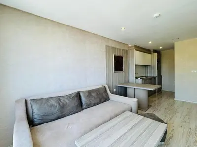 a living room with a couch and a kitchen at PARADISO B 306 Sea View Apartment Nessebar in Nesebar