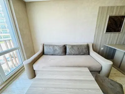 a couch in a small room with a window at PARADISO B 306 Sea View Apartment Nessebar in Nesebar