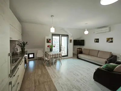 a living room with a couch and a table at Уютная квартира рядом с центром Бургаса in Burgas City