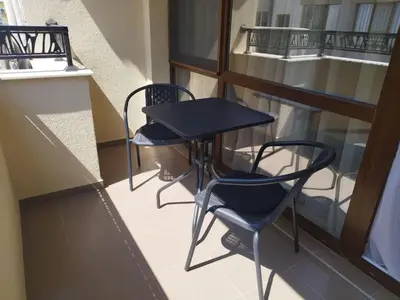 a small table and chairs on a balcony at BoriSun with Free Parking space in Burgas City