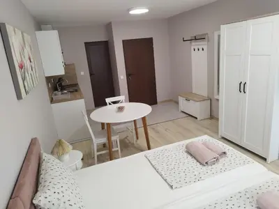 a room with a bed and a table and a table at BoriSun with Free Parking space in Burgas City