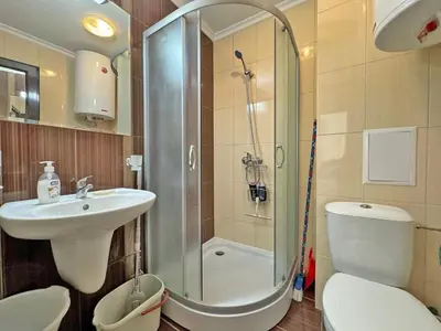 a bathroom with a shower and a toilet and a sink at 2 rooms Astoria 2 Elenite in Sveti Vlas