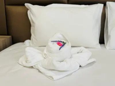a towel sitting on top of a bed at PARADISO B 411 Large SEA VIEW Studio Nessebar in Nesebar