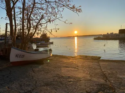 a boat sitting on the shore of a body of water at PARADISO B 411 Large SEA VIEW Studio Nessebar in Nesebar