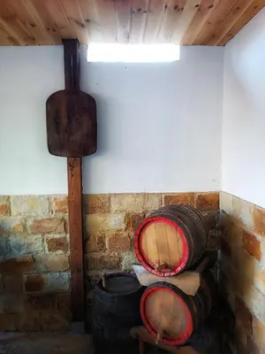 a room with wooden barrels and a wall at Боровата къща in Varna City