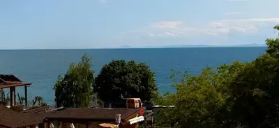 a view of the ocean from the roofs of houses at Villa Maria in Sveti Vlas