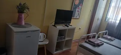 a room with a television on top of a dresser at Стая за двама в град Бургас in Burgas City