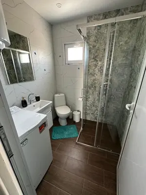 a bathroom with a shower and a sink and a toilet at Морски Бриз in Lozenets