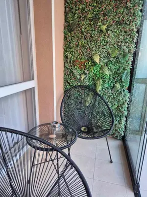a couple of chairs and a table on a balcony at Marea Garden, Ravda - Studio with Pool by Flat Mаnager in Ravda