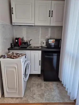 a kitchen with a washing machine and a sink at Marea Garden, Ravda - Studio with Pool by Flat Mаnager in Ravda