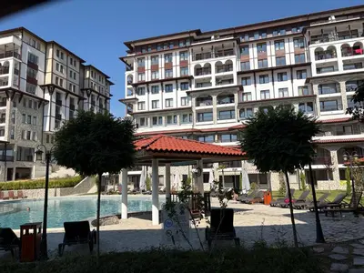 a pool in front of a building with chairs and trees at Etara 4 Sweti Wlas Apart Complex in Sveti Vlas