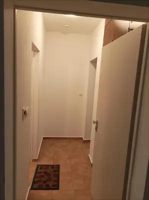 an empty hallway with a door and a tile floor at Марина Кеѝп, Ахелой in Aheloy