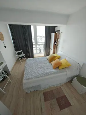 a bedroom with a large bed with yellow pillows at Level 5 in Burgas City
