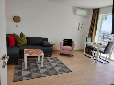 a living room with a couch and a table at Level 5 in Burgas City