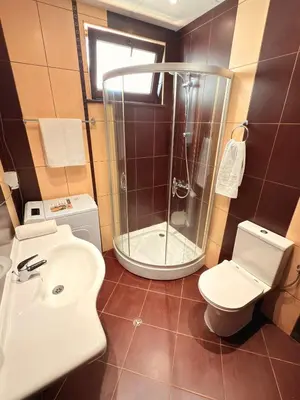 a bathroom with a shower and a toilet and a sink at Sweet home see view pool escape in Nesebar