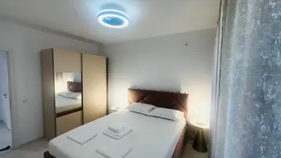 a small bedroom with a white bed with a mirror at JADORE DUNE Apartment 10 Sunny Beach in Sunny Beach