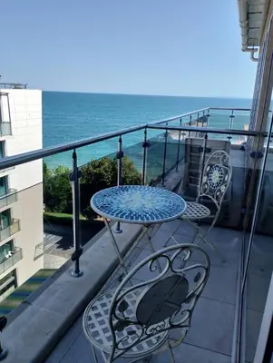 a table and chairs on a balcony with the ocean at Sea Studio 22 in Nesebar