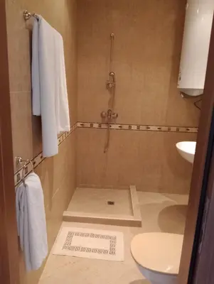 a bathroom with a shower and a toilet and a sink at Sea Studio 22 in Nesebar