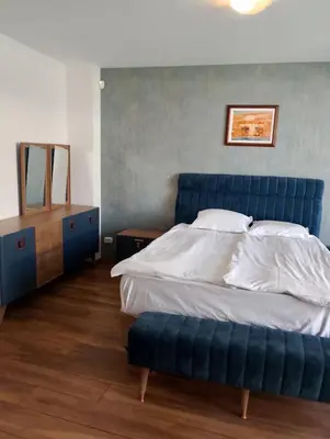 a bedroom with a blue bed and a blue ottoman at Sea Studio 22 in Nesebar