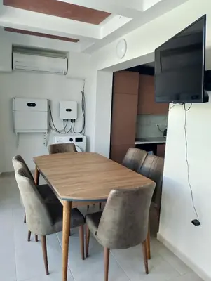 a dining room with a wooden table and chairs at Sea Studio 22 in Nesebar