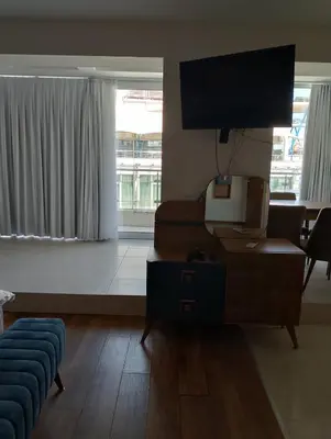 a living room with a couch and a flat screen tv at Sea Studio 22 in Nesebar