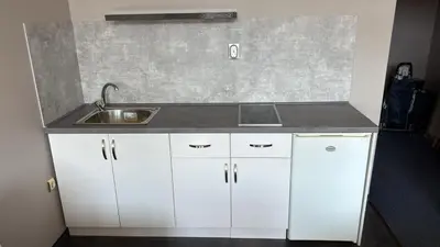 a kitchen with white cabinets and a sink at Jolka in Sunny Beach