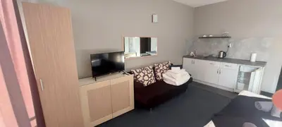 a living room with a couch and a flat screen tv at Jolka in Sunny Beach