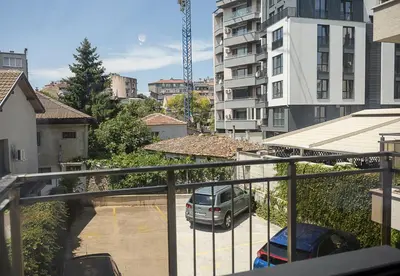 a balcony with a car parked in a parking lot at BuenaVista I Modern Comfort near Varna City Center by Flat Mаnаger in Varna City