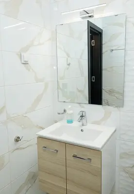 a bathroom with a sink and a mirror at BuenaVista I Modern Comfort near Varna City Center by Flat Mаnаger in Varna City