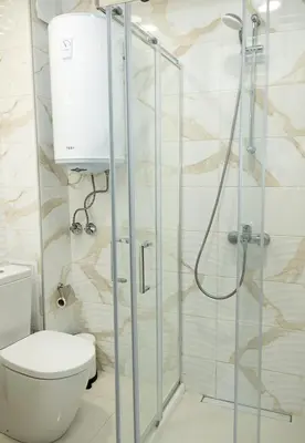 a bathroom with a toilet and a glass shower stall at BuenaVista I Modern Comfort near Varna City Center by Flat Mаnаger in Varna City