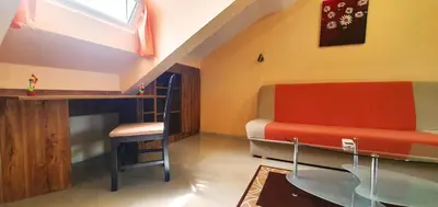 a bedroom with a bed and a table and a chair at Top Floor Two Bedroom Apartment in Central Burgas in Burgas City