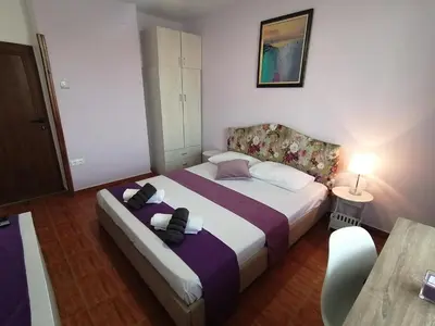 a hotel room with two beds and a table at Guest House Bа́kish Obzor in Obzor