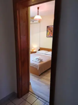 a view of a bedroom with a bed through a doorway at Guest House Bа́kish Obzor in Obzor