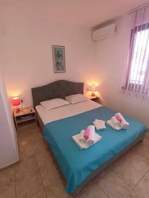 a bedroom with a bed with two towels on it at Guest House Bа́kish Obzor in Obzor