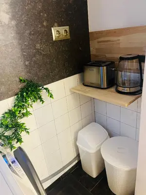 a small kitchen with a toilet and a toaster at Detelina Apartment Bee Happy in Burgas in Burgas City
