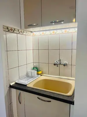 a kitchen with a sink and a keyboard on a counter at Detelina Apartment Bee Happy in Burgas in Burgas City