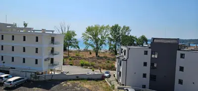 an aerial view of two buildings and a parking lot at Cozy sea view studios in Sozopol
