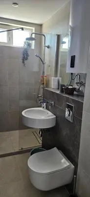 a bathroom with a toilet and a sink at Cozy sea view studios in Sozopol